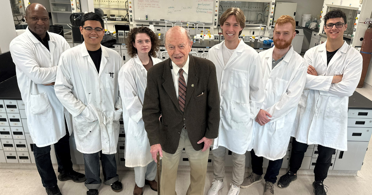Professor Robert Stairs with 6 students in the lab