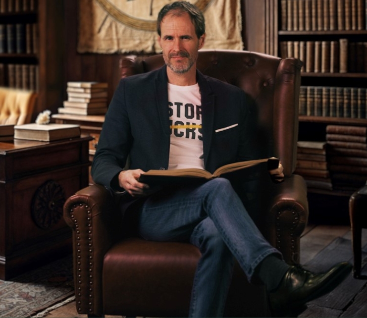 Dr. Christopher Dummitt sitting on a sofa
