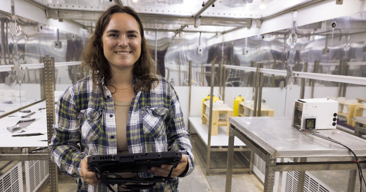 A girl smiling holding a tablet