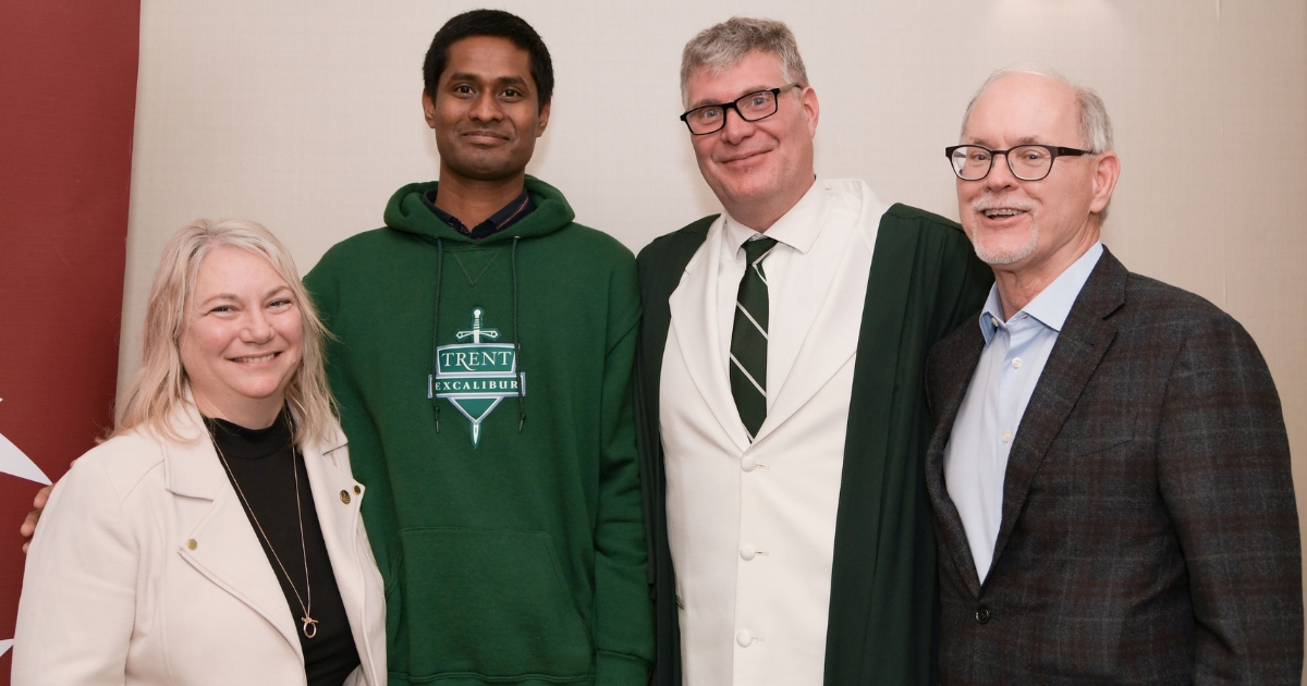 Dr. Cathy Bruce and three guys taking a picture